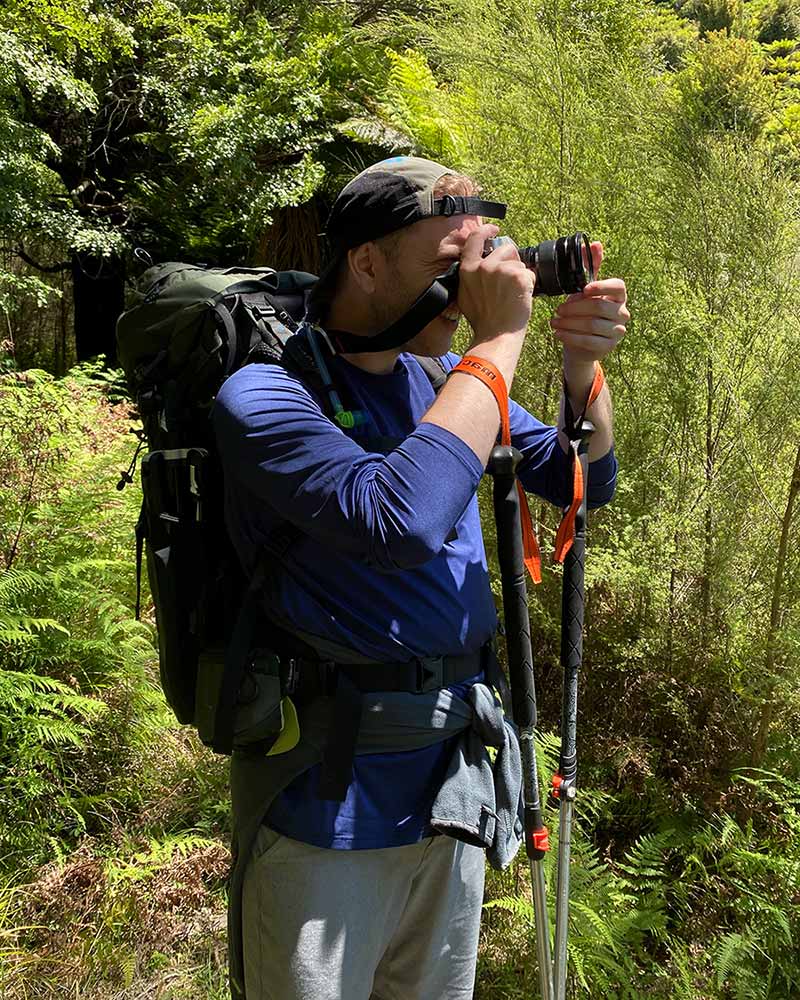 Jonny looking out into the distance to find the perfect scene to capture with his camera